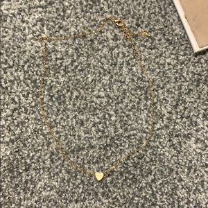 gold chain necklace with a small heart
